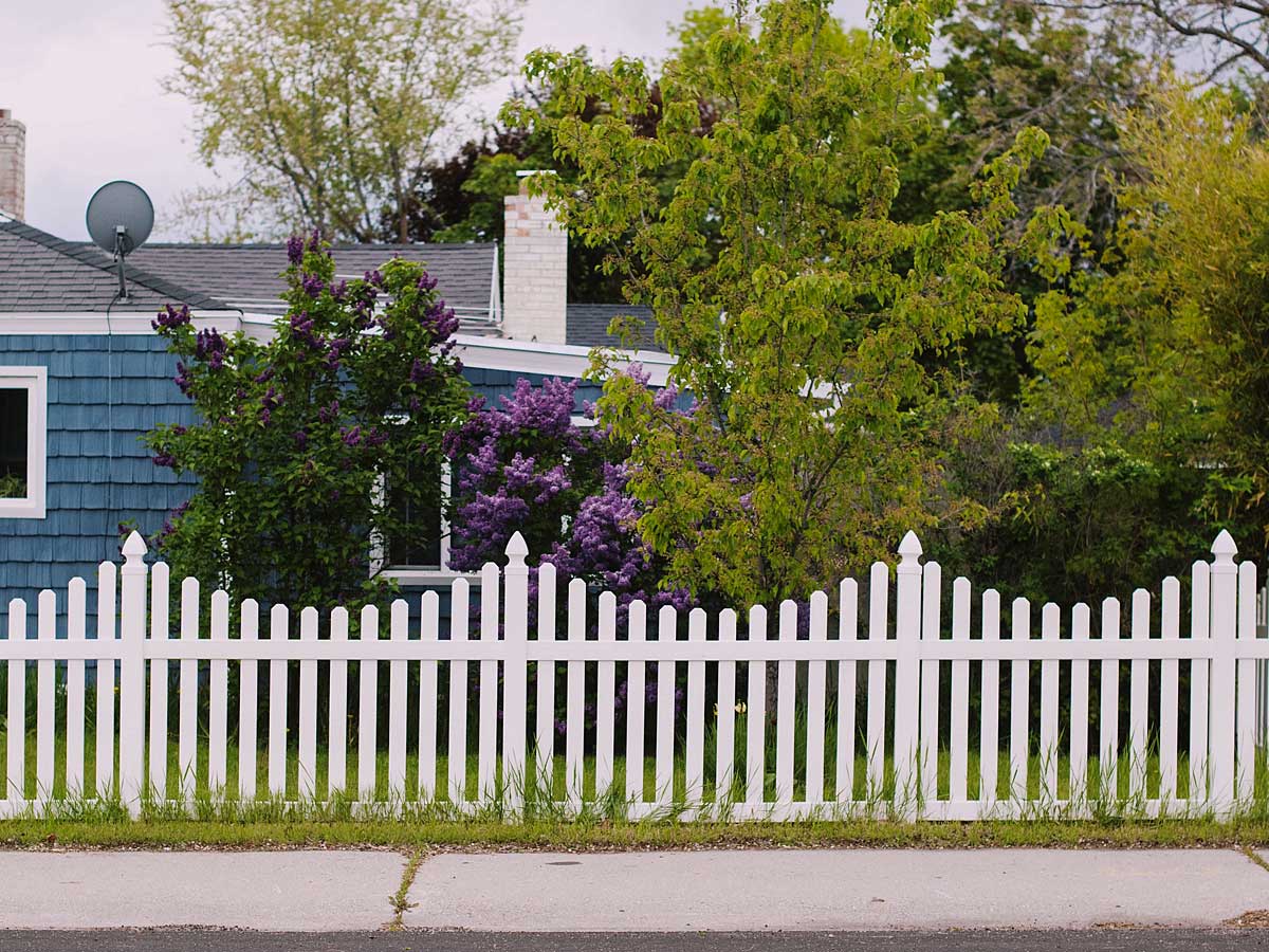 Blue House With White Fence