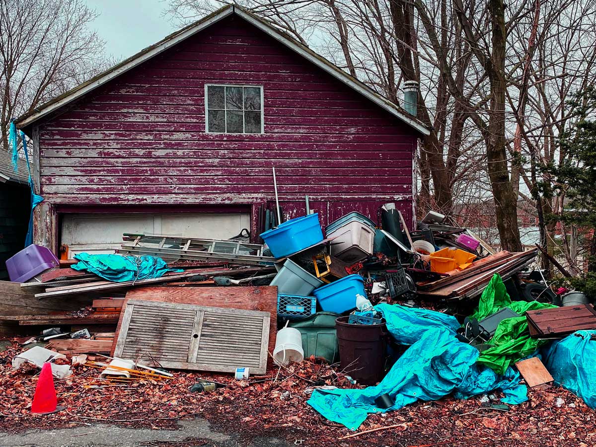 Junk Piled In Front Of Barn