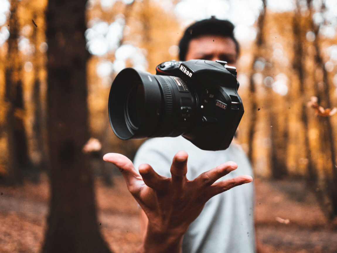Man Tossing Nikon Camera